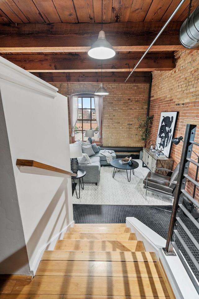 interior space featuring wooden ceiling, a fireplace, brick wall, and hardwood / wood-style flooring