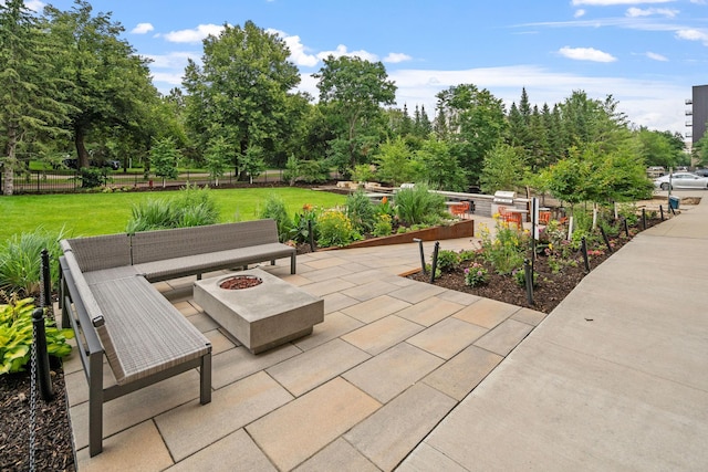 view of patio featuring an outdoor living space with a fire pit