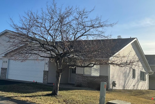 view of side of property featuring a yard and a garage