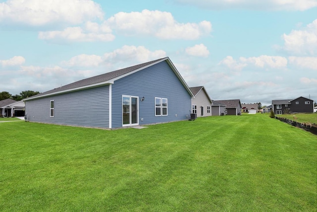 rear view of property with a lawn