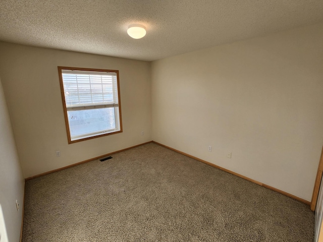 unfurnished room with carpet floors and a textured ceiling