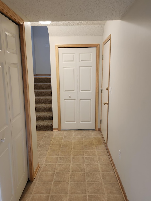 hallway featuring a textured ceiling