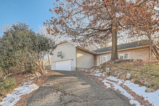 view of snowy exterior with a garage