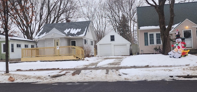 view of front of property featuring a garage and an outbuilding