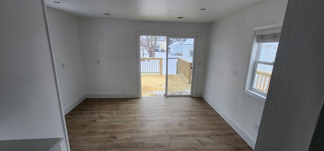 unfurnished room with a healthy amount of sunlight and wood-type flooring