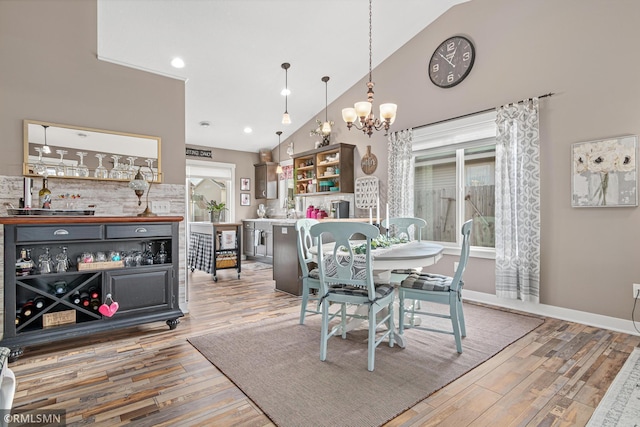 dining room with a chandelier, light hardwood / wood-style floors, and a wealth of natural light