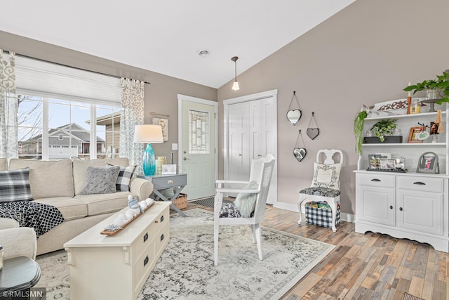 living room featuring light hardwood / wood-style floors and lofted ceiling