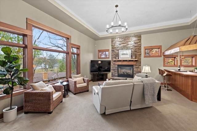 living room with an inviting chandelier, light carpet, and a tray ceiling