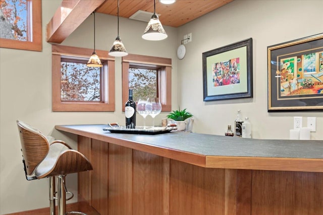 bar with hanging light fixtures and wood ceiling