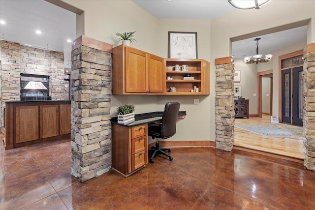 office space featuring built in desk and a chandelier