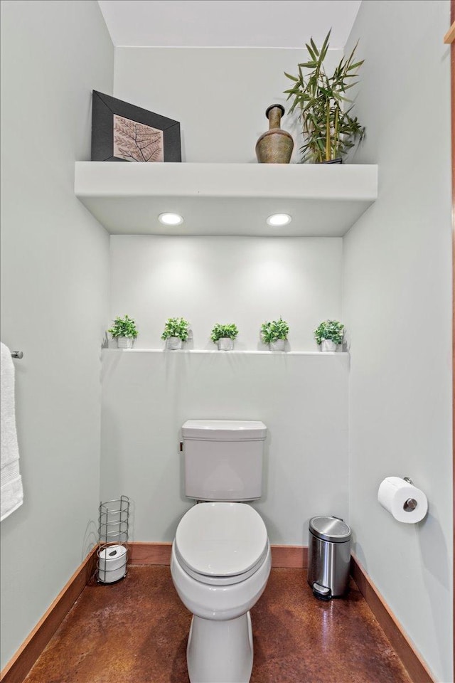 bathroom featuring toilet and concrete flooring