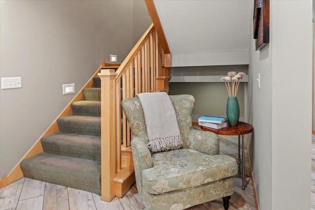 stairway featuring hardwood / wood-style flooring and a textured ceiling