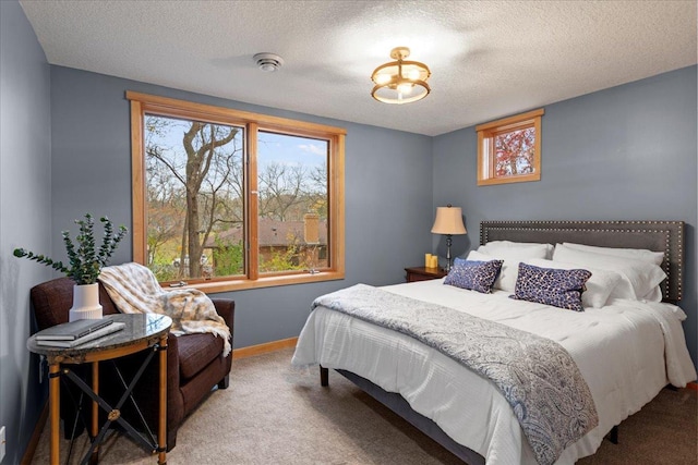 bedroom with carpet flooring and a textured ceiling