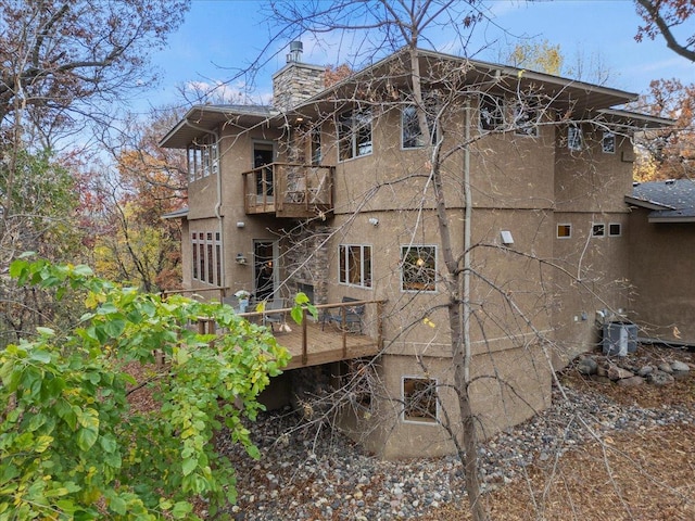 view of side of home with a balcony