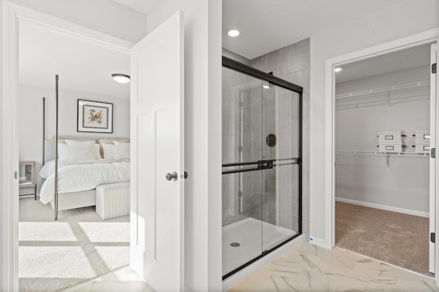 bathroom featuring a shower with shower door