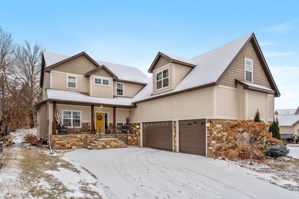 view of front of home featuring a porch and a garage