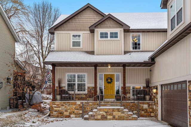 view of front of home with a porch and a garage