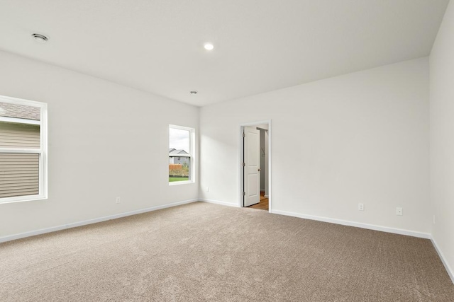 carpeted spare room with recessed lighting and baseboards