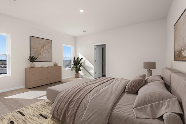 bedroom with recessed lighting, light colored carpet, and baseboards