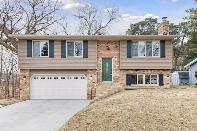 raised ranch with a storage unit and a garage