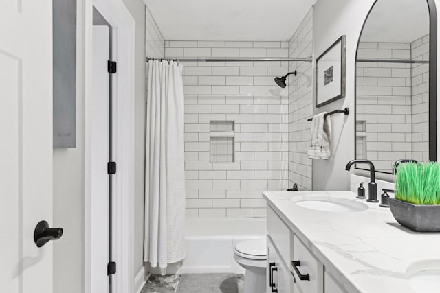 full bathroom with vanity, shower / tub combo, and toilet