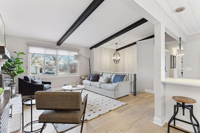 living room with beamed ceiling, light hardwood / wood-style flooring, and a chandelier