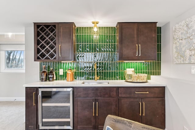 bar with decorative backsplash, dark brown cabinetry, wine cooler, and sink