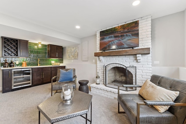 carpeted living room featuring a fireplace, wine cooler, and bar area