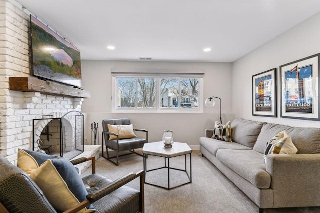 carpeted living room with a brick fireplace