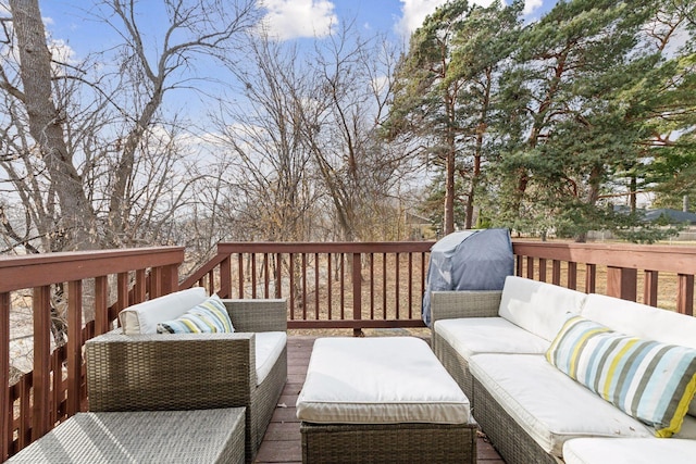 wooden terrace with an outdoor living space