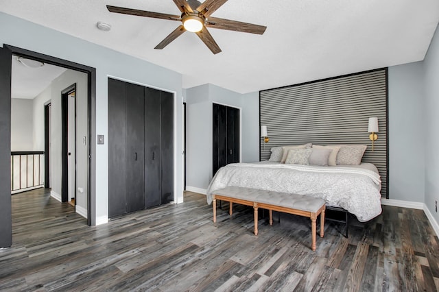 bedroom with ceiling fan, dark hardwood / wood-style floors, and a textured ceiling