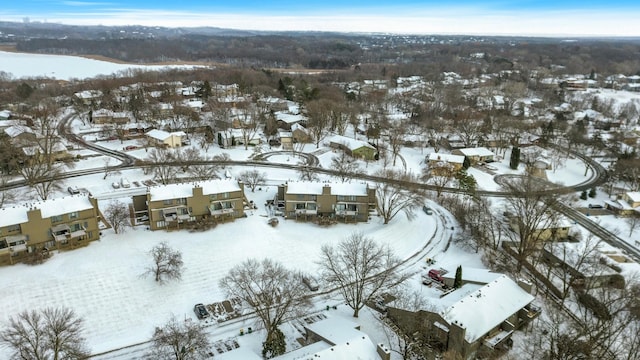 snowy aerial view with a residential view