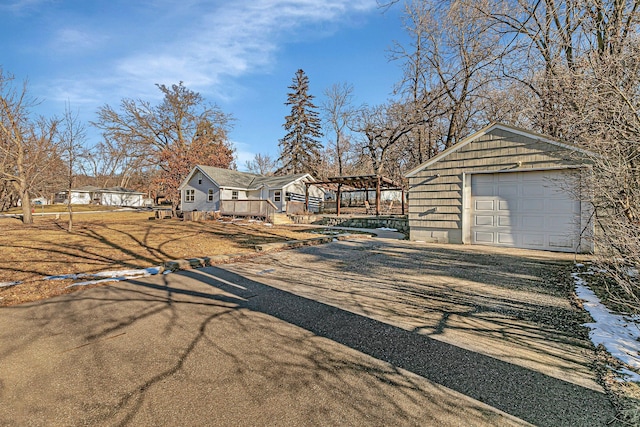 exterior space featuring a garage and an outbuilding