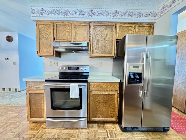 kitchen featuring light parquet flooring and stainless steel appliances