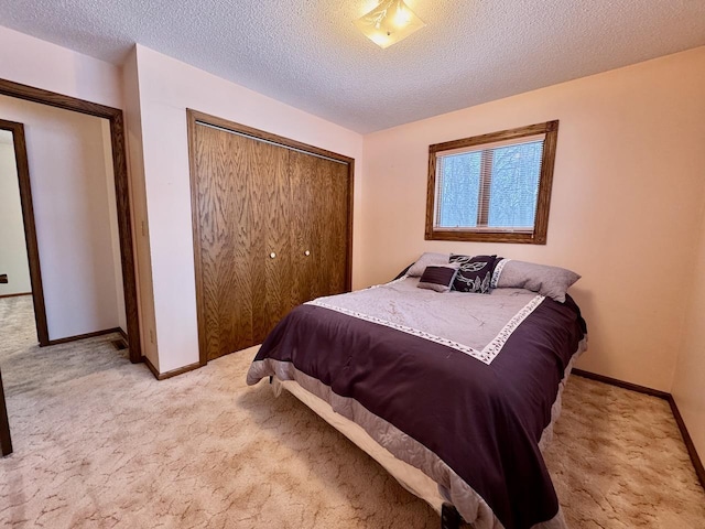 bedroom featuring light carpet, a closet, and a textured ceiling