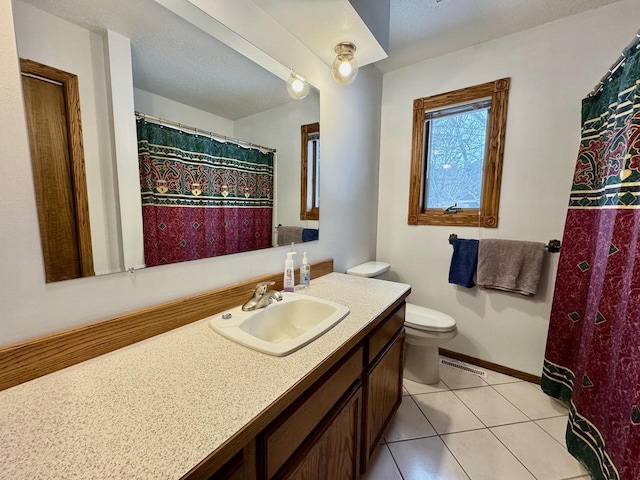 bathroom with tile patterned flooring, vanity, and toilet