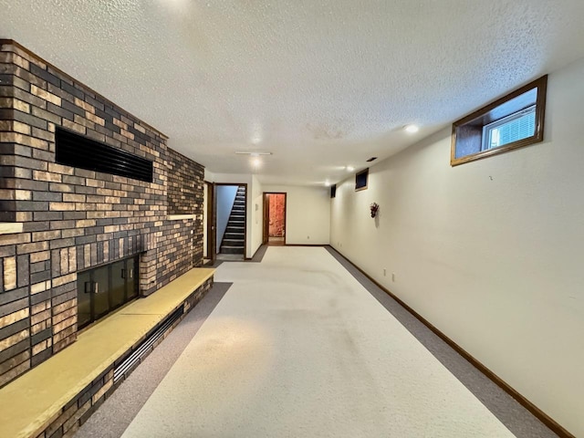 basement with a fireplace, a textured ceiling, and light carpet