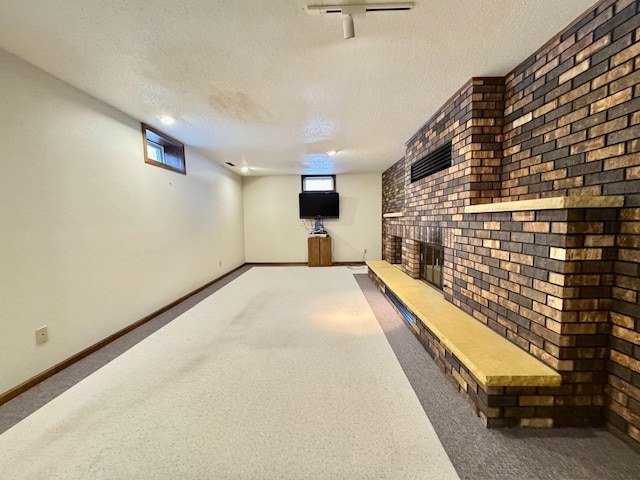 basement with a textured ceiling and carpet floors