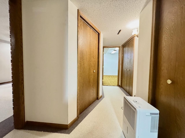 hall with a textured ceiling