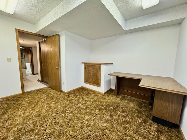 bonus room with dark colored carpet and a textured ceiling