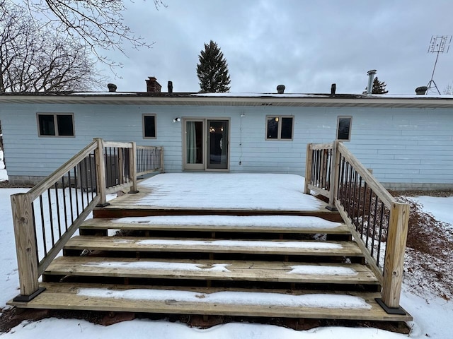 snow covered property featuring a deck