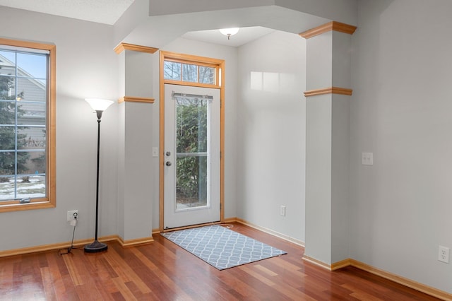 entryway with wood finished floors and baseboards