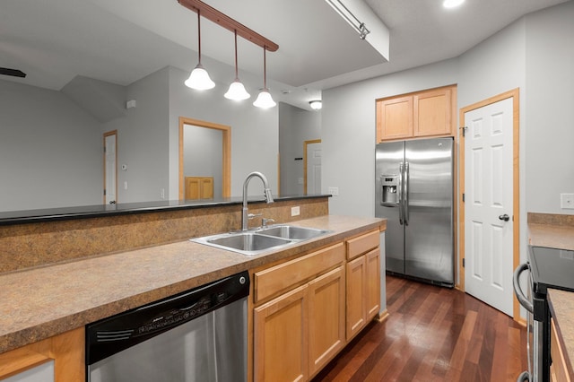 kitchen with stainless steel appliances, light countertops, hanging light fixtures, light brown cabinetry, and a sink