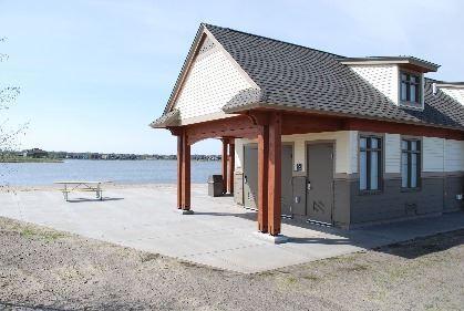 exterior space featuring a water view, a patio area, and a view of the beach