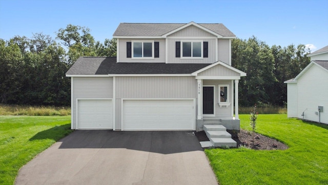 view of front of property featuring a garage and a front lawn