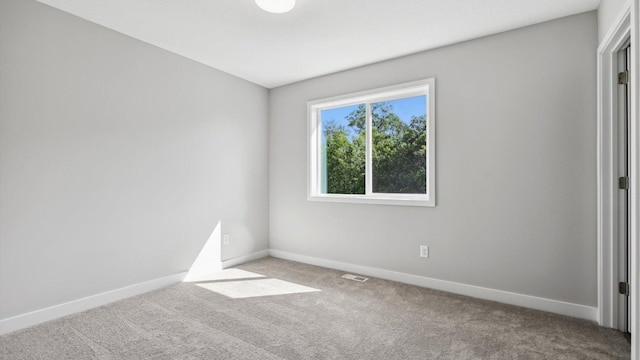 unfurnished room featuring light carpet