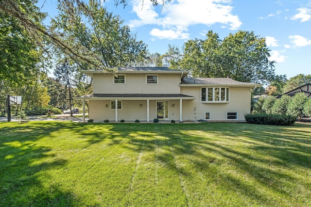 rear view of property with a yard