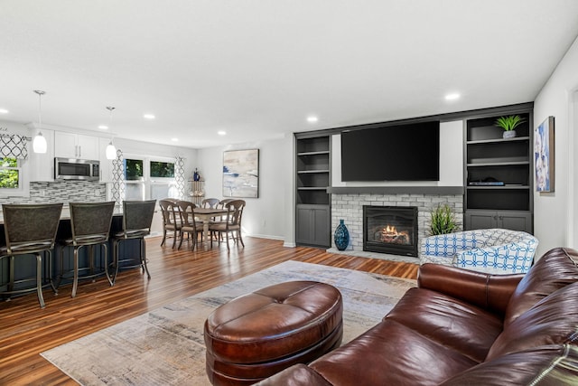 living room featuring hardwood / wood-style flooring and a fireplace