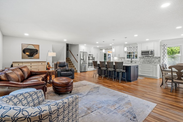 living room with sink and light wood-type flooring