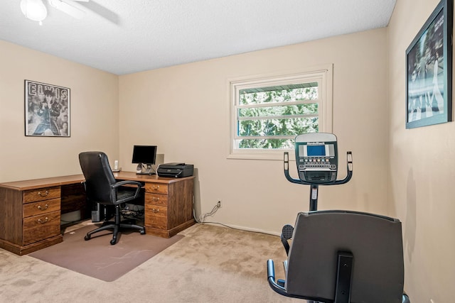 office featuring ceiling fan, light colored carpet, and a textured ceiling